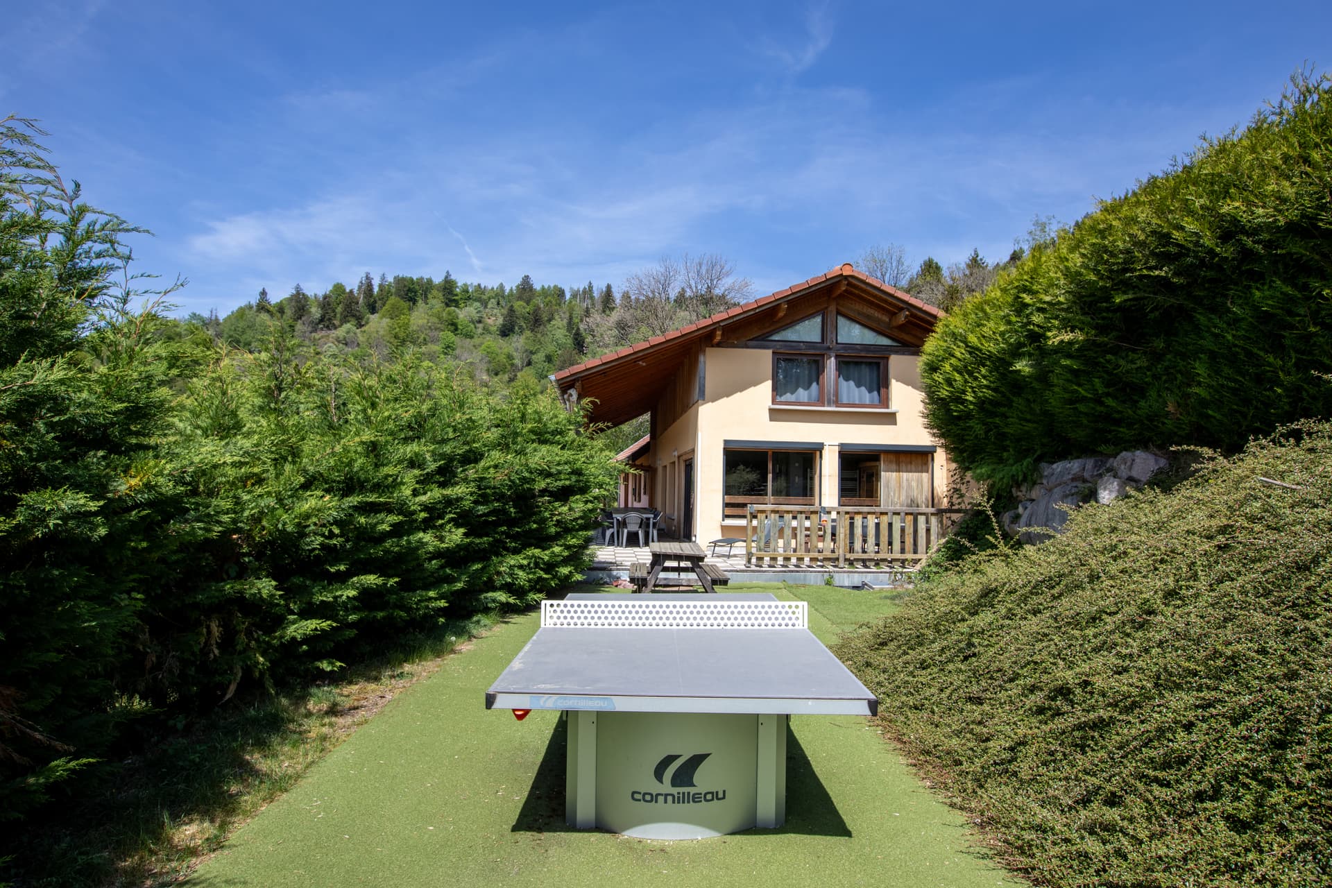 Façade arrière du gîte Jonquille avec table de ping-pong dans le jardin